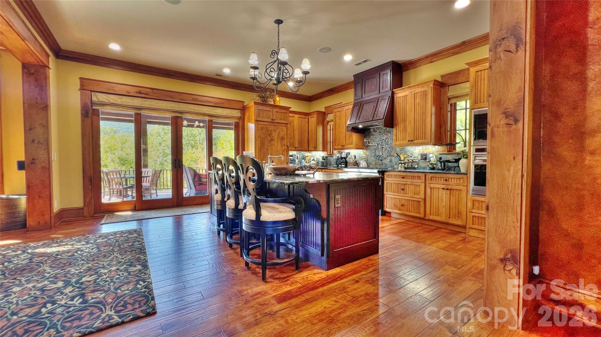 538 Chestertown Drive Mill Spring, NC 28756 - Photo 29 of 48 a open kitchen with stainless steel appliances granite countertop a stove dining table and chairs with wooden floor