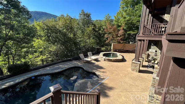 a swimming pool with outdoor seating and yard