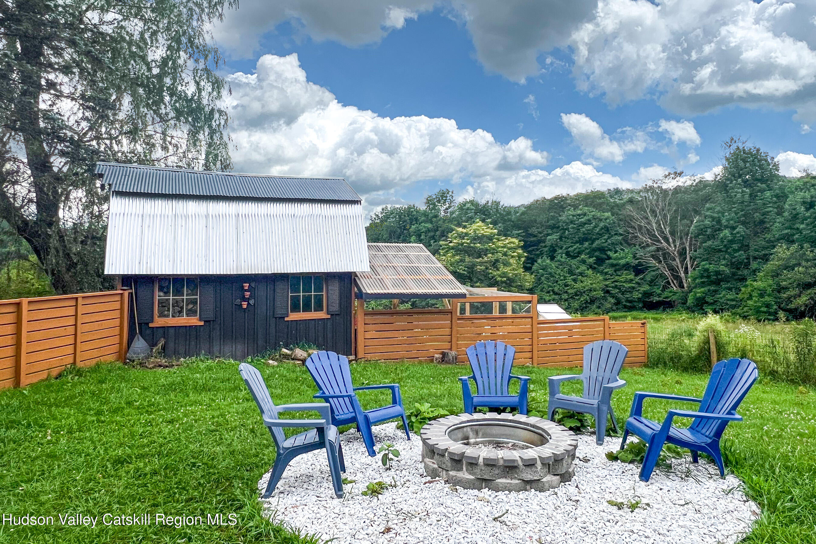 1399 Arbuckle Hollow Road Delhi, NY 13752 - Photo 40 of 64 a view of a chairs and table in backyard