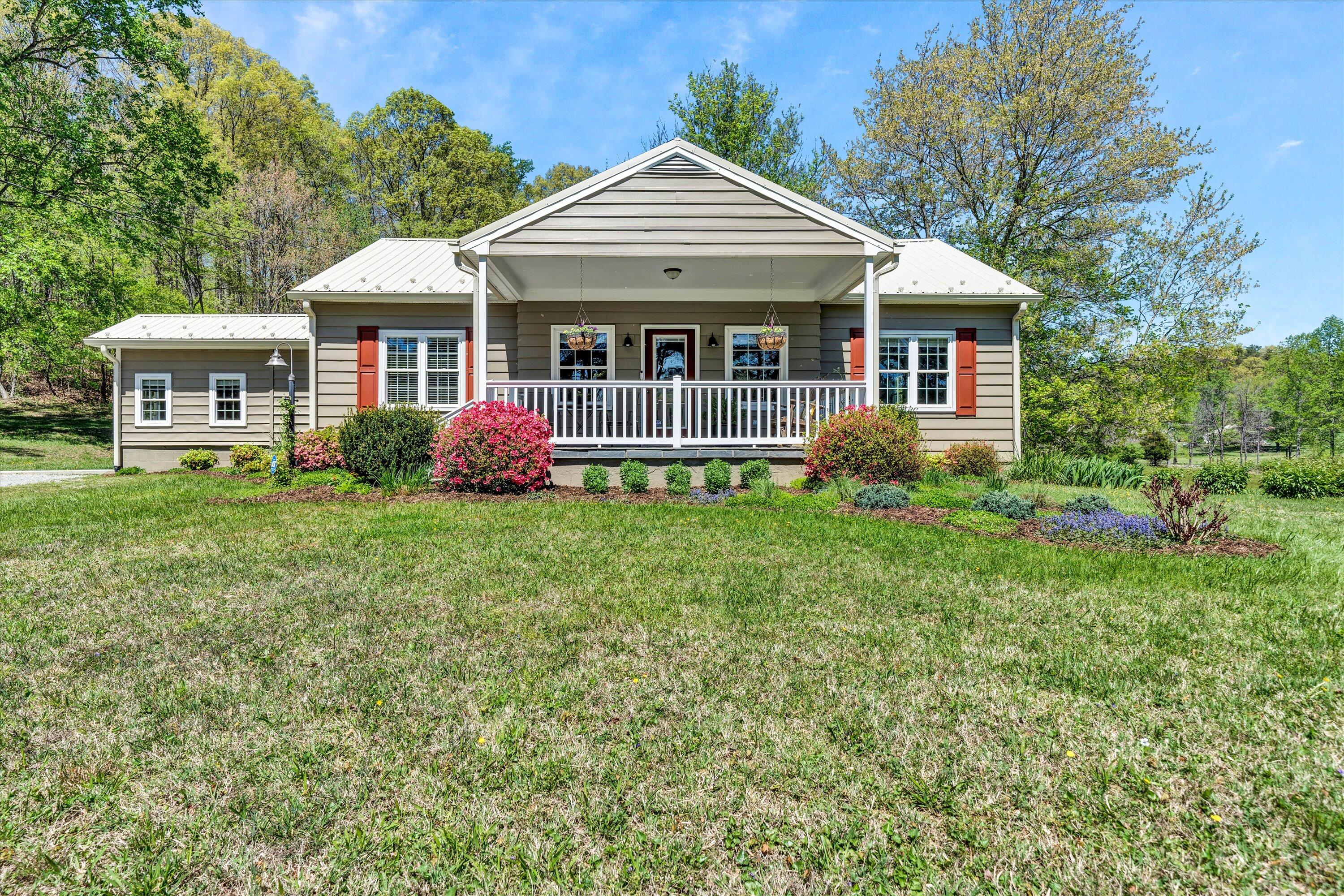1186 Camp Jaycee Road Blue Ridge, VA 24064 - Photo 1 of 54 a front view of a house with garden