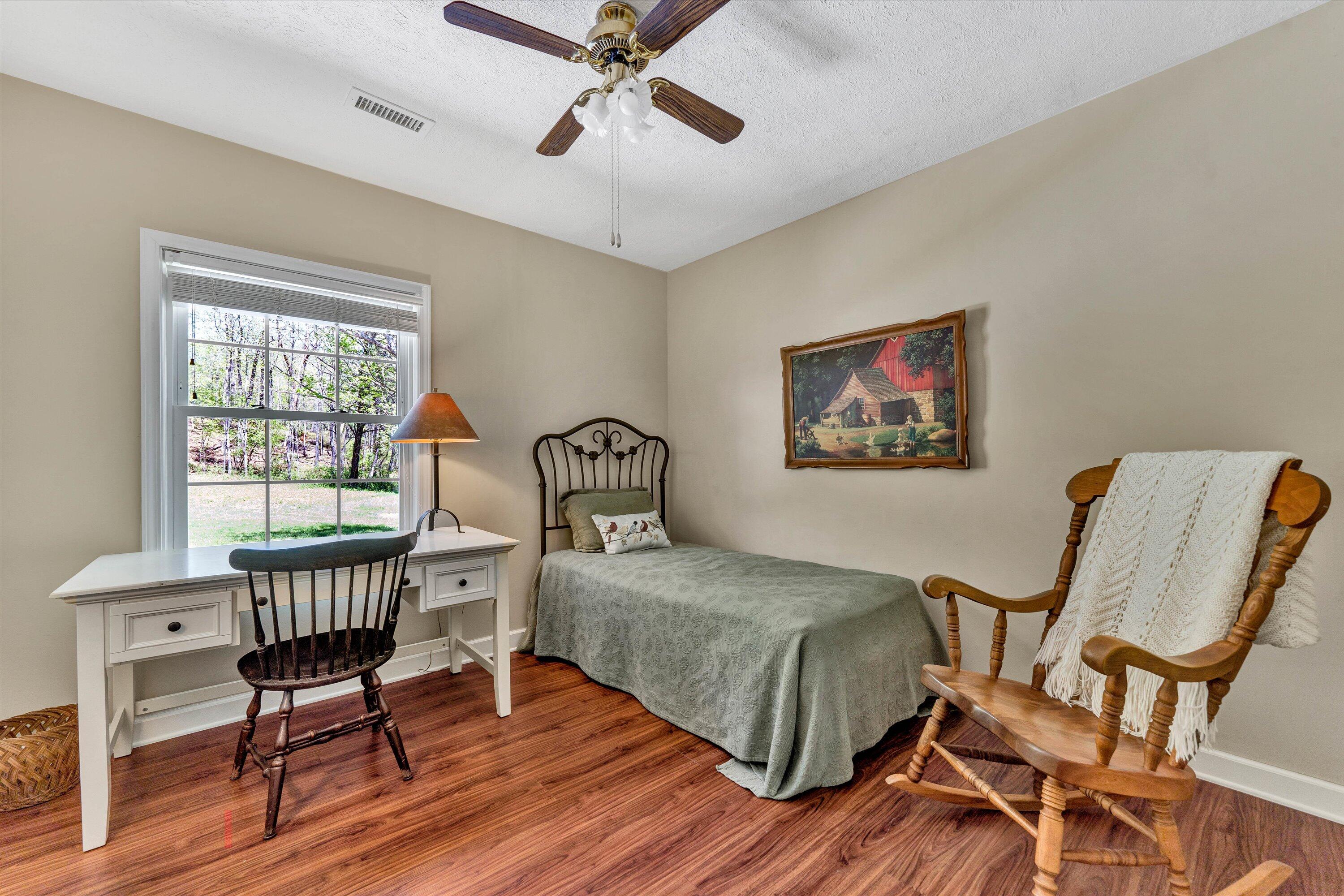 1186 Camp Jaycee Road Blue Ridge, VA 24064 - Photo 29 of 54 a bedroom with a bed and wooden floor
