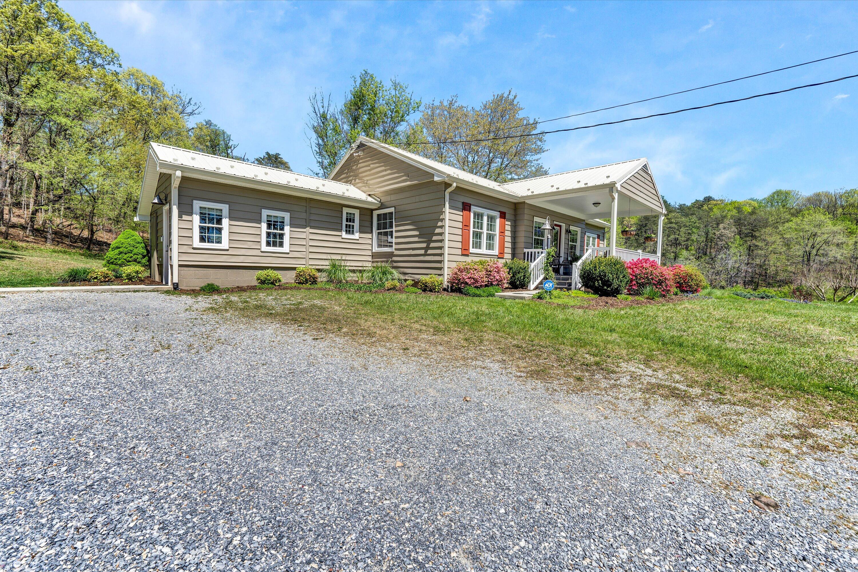 1186 Camp Jaycee Road Blue Ridge, VA 24064 - Photo 39 of 54 a front view of a house with a garden