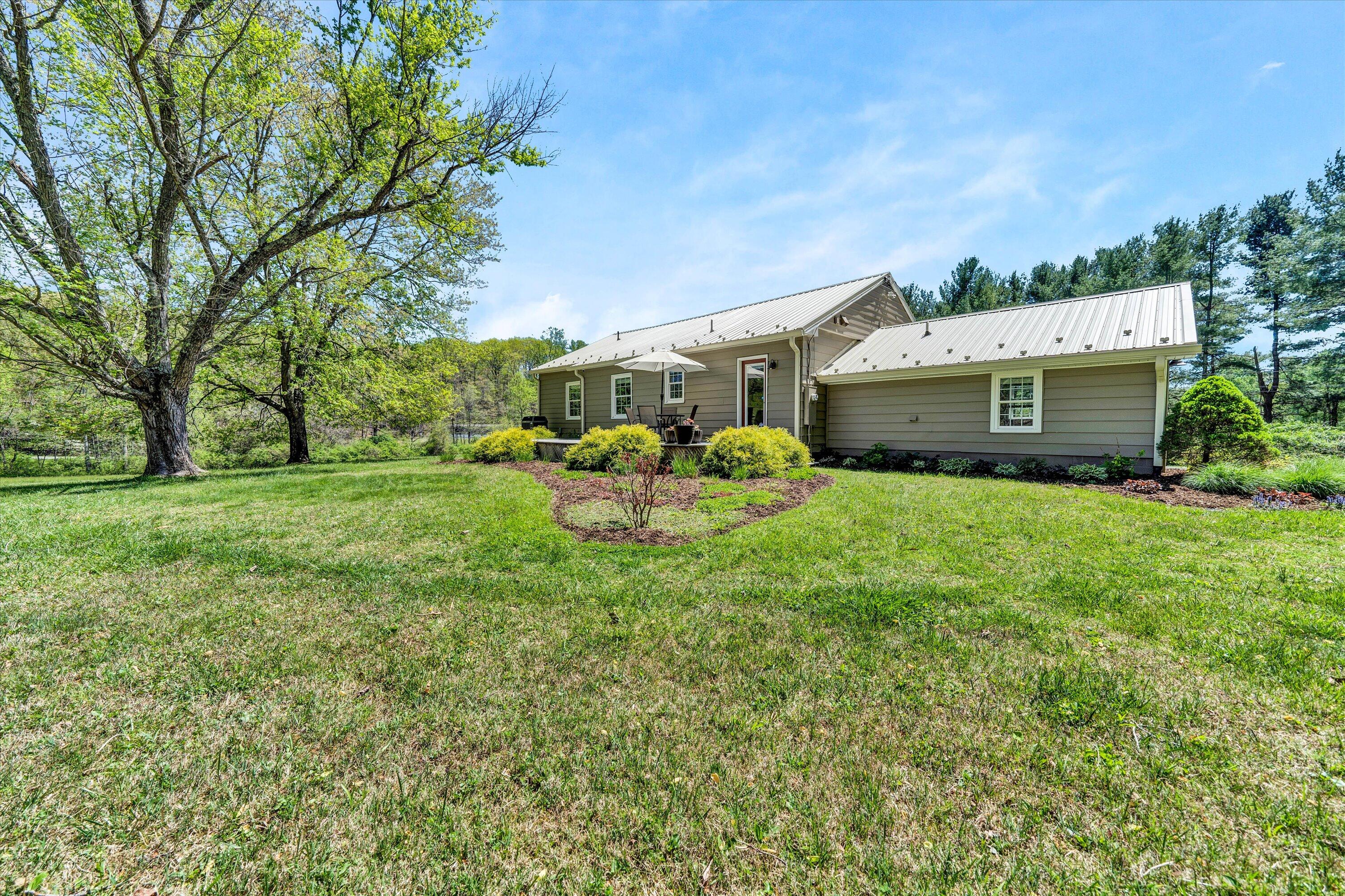1186 Camp Jaycee Road Blue Ridge, VA 24064 - Photo 43 of 54 a view of a house with a big yard and large trees