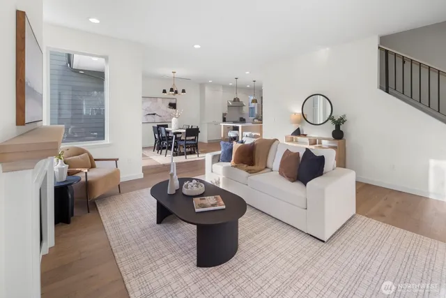 a living room with furniture a rug and a table