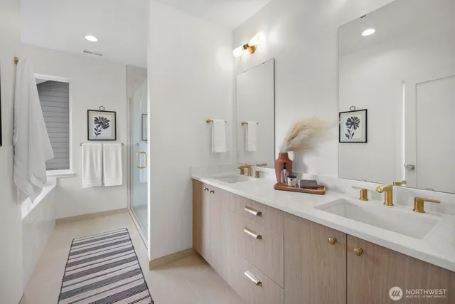 a bathroom with a double vanity sink a mirror and a shower