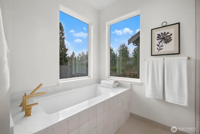a bathroom with bathtub and window
