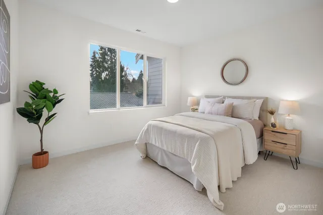 a bedroom with a bed and a large window