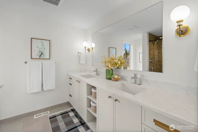 a kitchen with white cabinets and sink