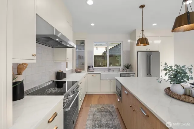 a large kitchen with a stove and a sink