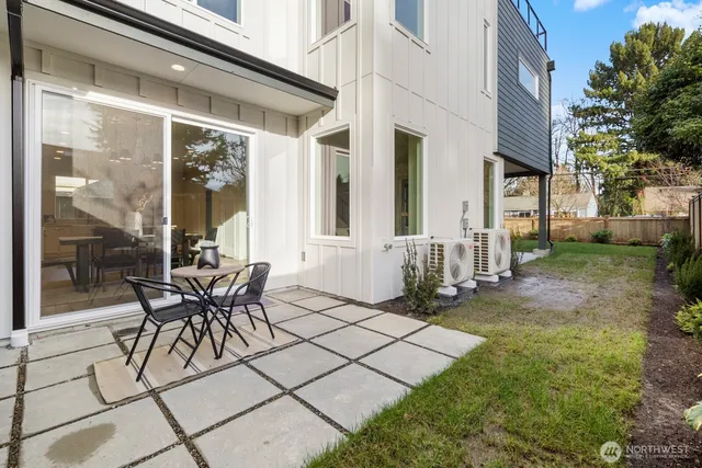 a view of a patio with table and chairs and wooden floor