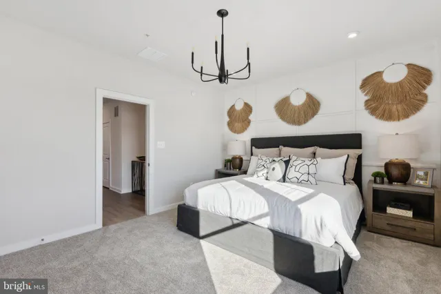 a bedroom with a bed and painting on the wall