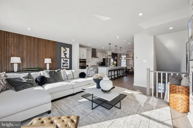 a living room with furniture and kitchen view