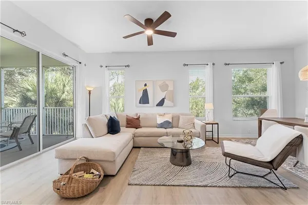 a living room with furniture and a lamp