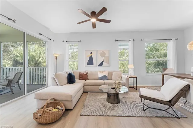 a living room with furniture and a lamp
