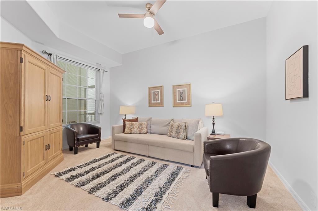8217 Parkstone Place, Unit 308 Naples, FL 34120 - Photo 14 of 50 a living room with furniture and a lamp