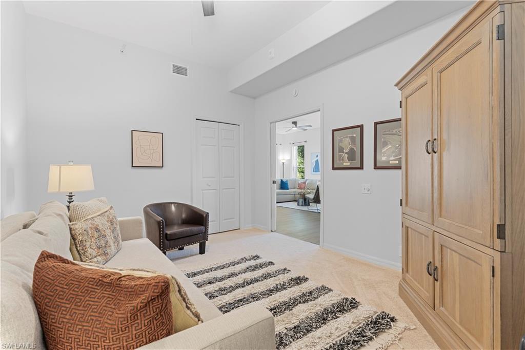 8217 Parkstone Place, Unit 308 Naples, FL 34120 - Photo 15 of 50 a bedroom with furniture and a wooden floor