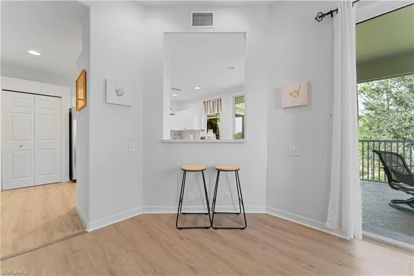 a kitchen with white cabinets and appliances