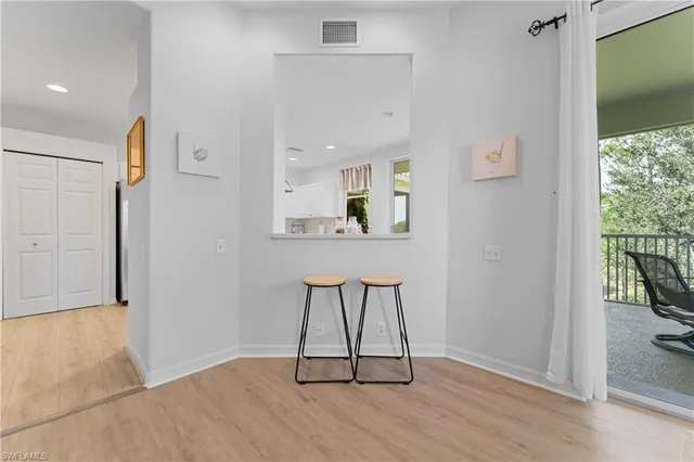 a kitchen with white cabinets and appliances