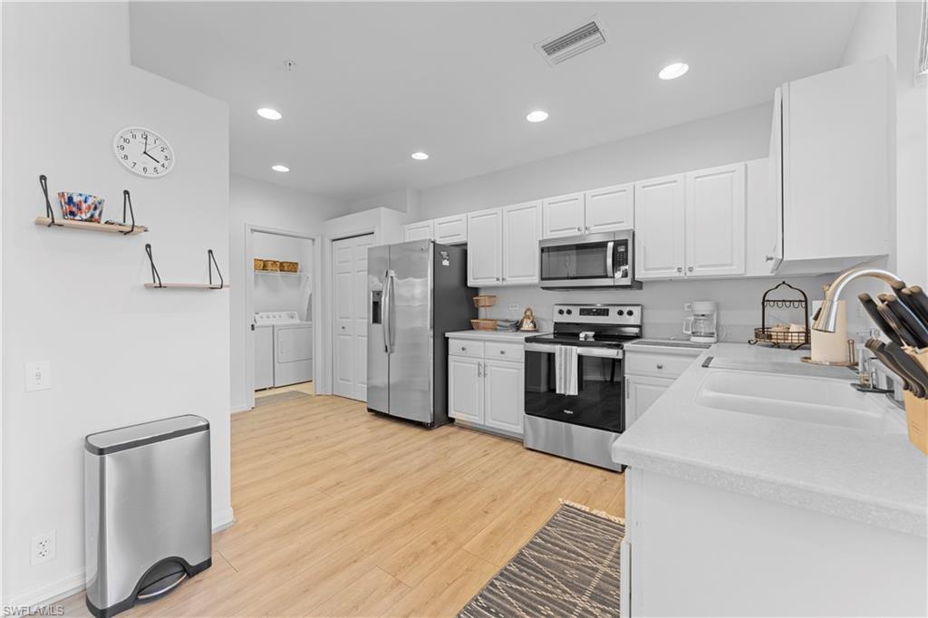 8217 Parkstone Place, Unit 308 Naples, FL 34120 - Photo 19 of 50 a kitchen with granite countertop a refrigerator and a stove top oven
