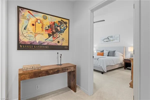 a bedroom with a bed and painting on the wall