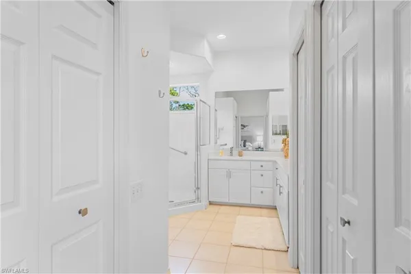 a bathroom with a shower sink vanity and mirror