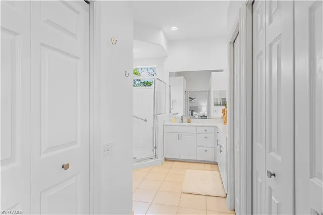 a bathroom with a shower sink vanity and mirror