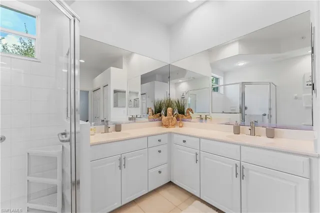 a bedroom with two beds and painting on the wall