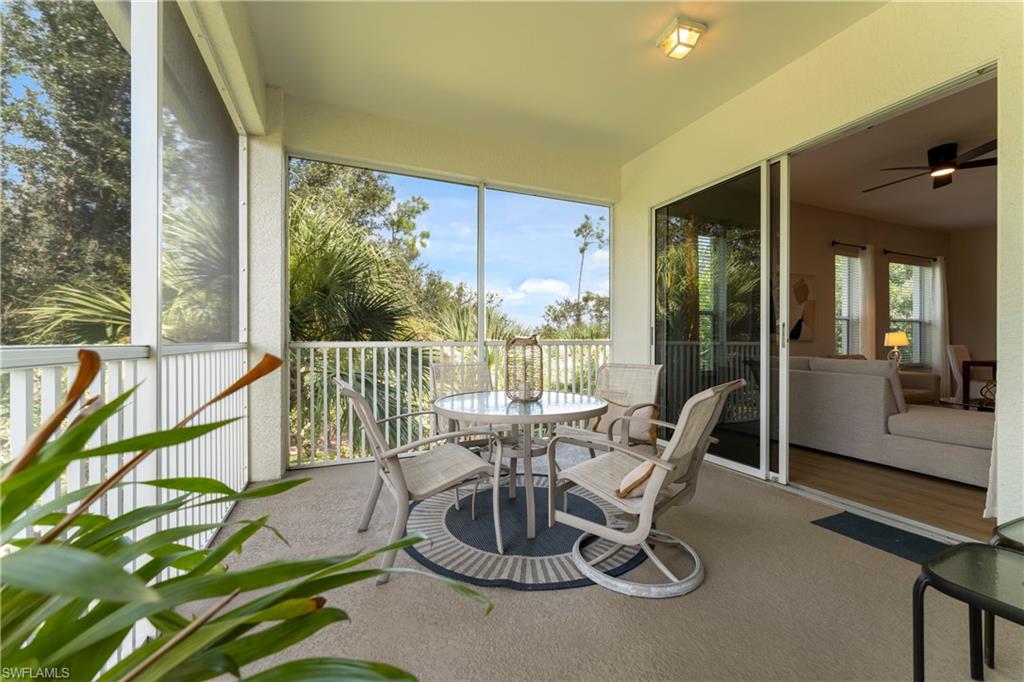 8217 Parkstone Place, Unit 308 Naples, FL 34120 - Photo 33 of 50 a dining room with furniture water view and a large window