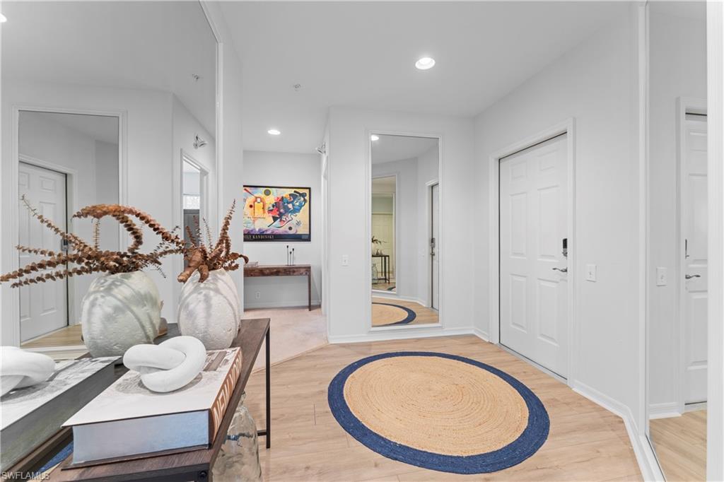 8217 Parkstone Place, Unit 308 Naples, FL 34120 - Photo 8 of 50 a bathroom with a toilet a sink and mirror