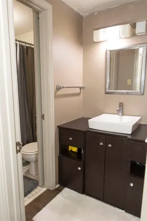 a bathroom with a sink vanity and toilet