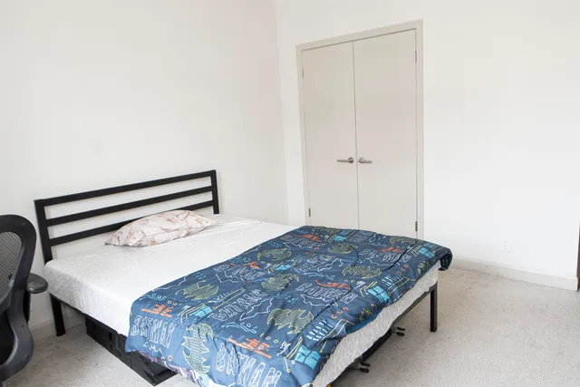 a bedroom with a bed and window