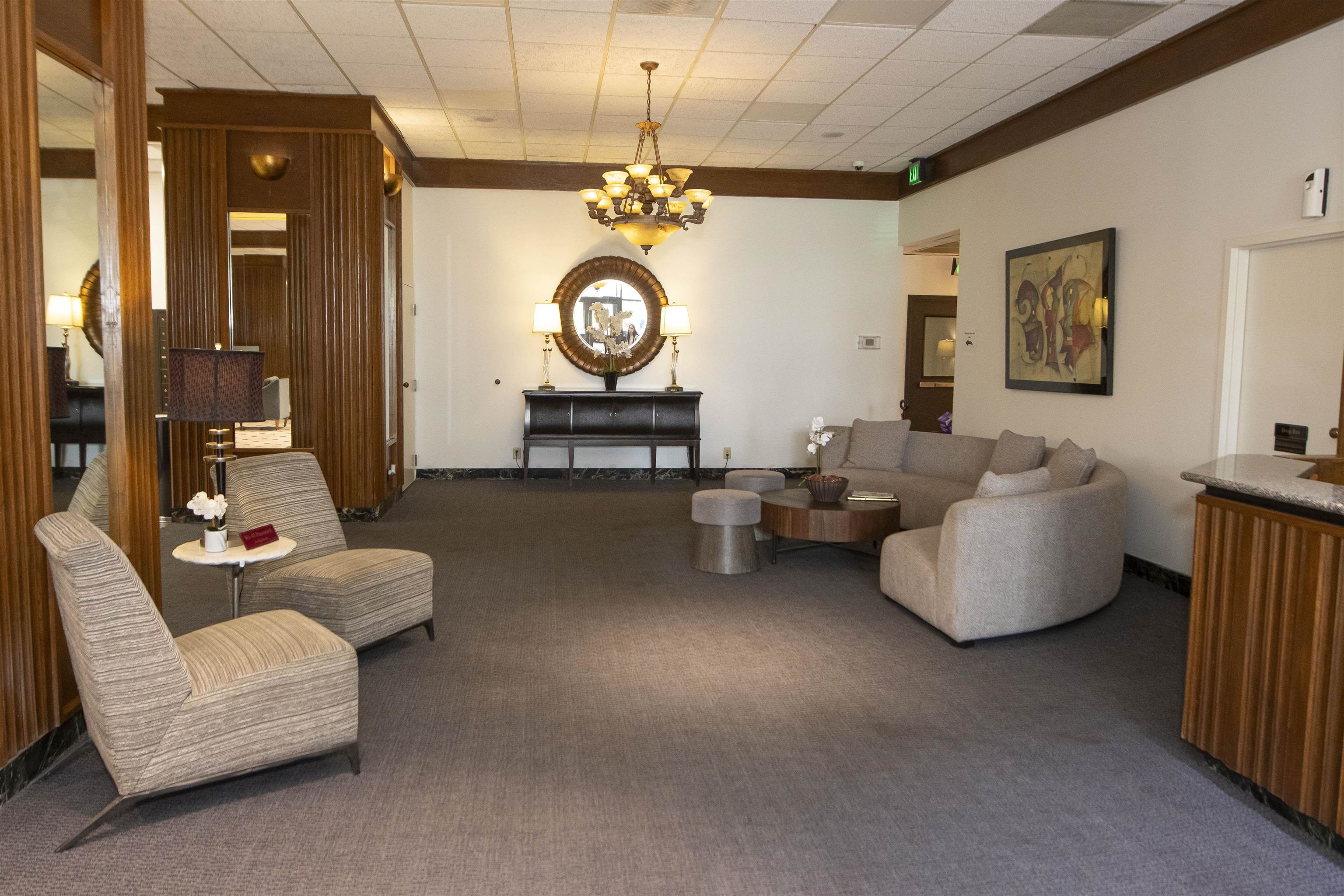 109 North Main Street, Unit 514 Memphis, TN 38103 - Photo 12 of 19 Living area with carpet floors, a chandelier, and a drop ceiling