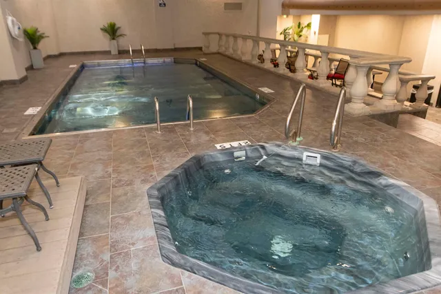 a backyard of a house with barbeque oven table and chairs