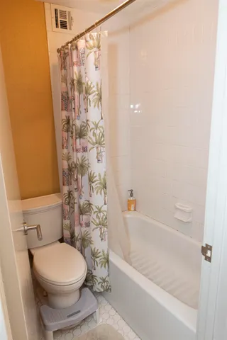 a bathroom with a sink vanity and toilet