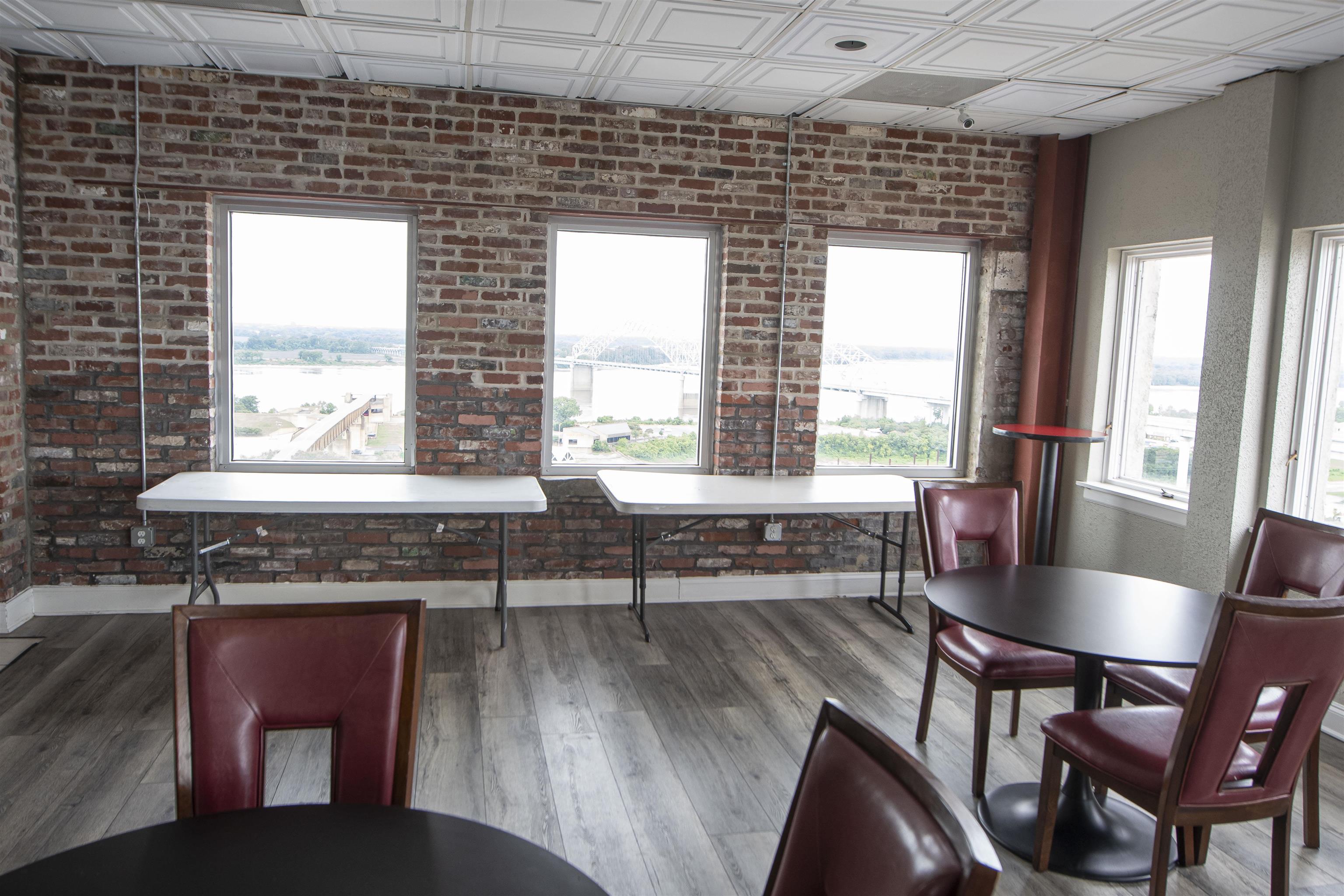 109 North Main Street, Unit 514 Memphis, TN 38103 - Photo 17 of 19 Dining area featuring an ornate ceiling, wood finished floors, and brick wall
