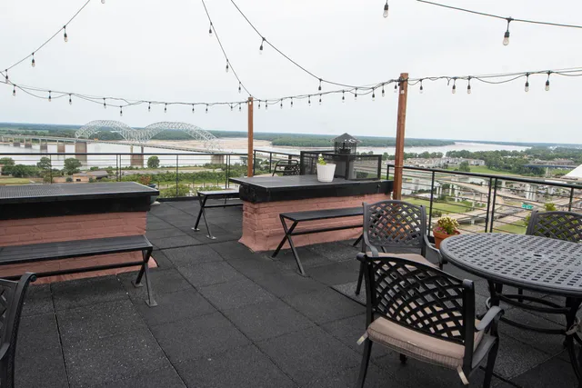 a view of a balcony with two chairs and a table