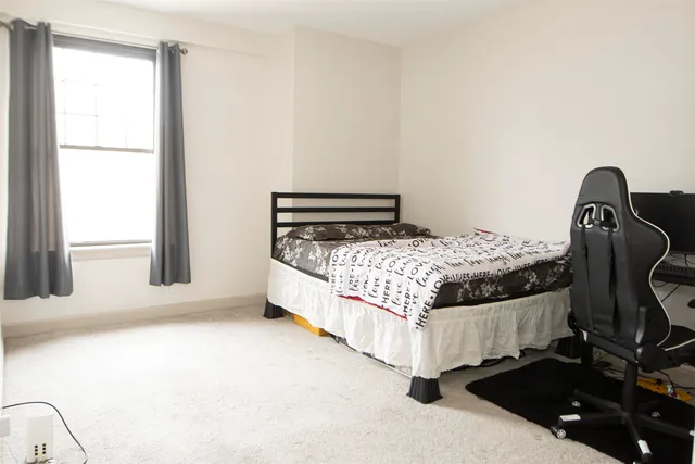 a bathroom with a granite countertop toilet sink and mirror