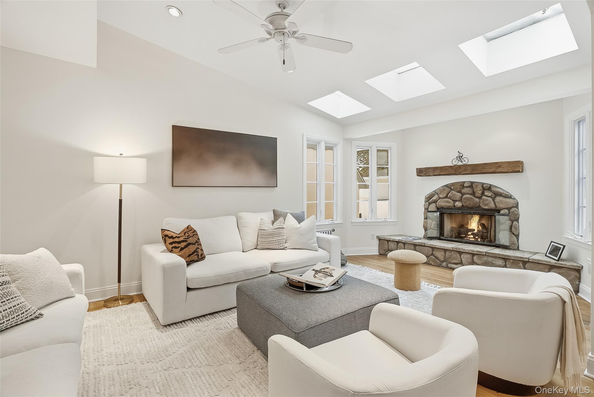 1 Oneida Street Rye, NY 10580 - Photo 12 of 32 a living room with furniture a fireplace and a chandelier