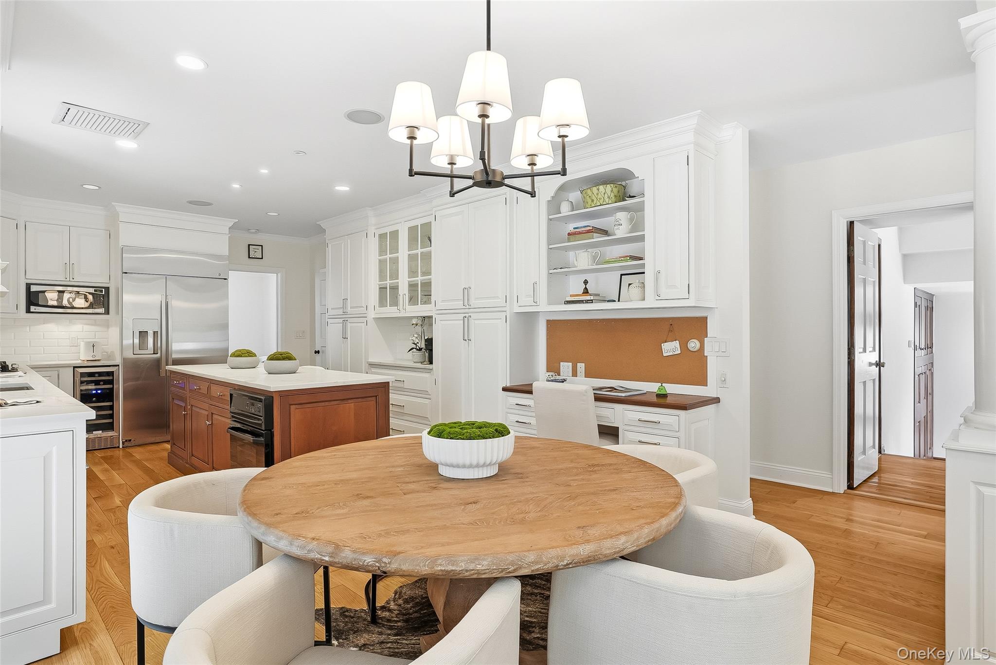 1 Oneida Street Rye, NY 10580 - Photo 14 of 32 a dining room with wooden floor a chandelier a wooden table and chairs