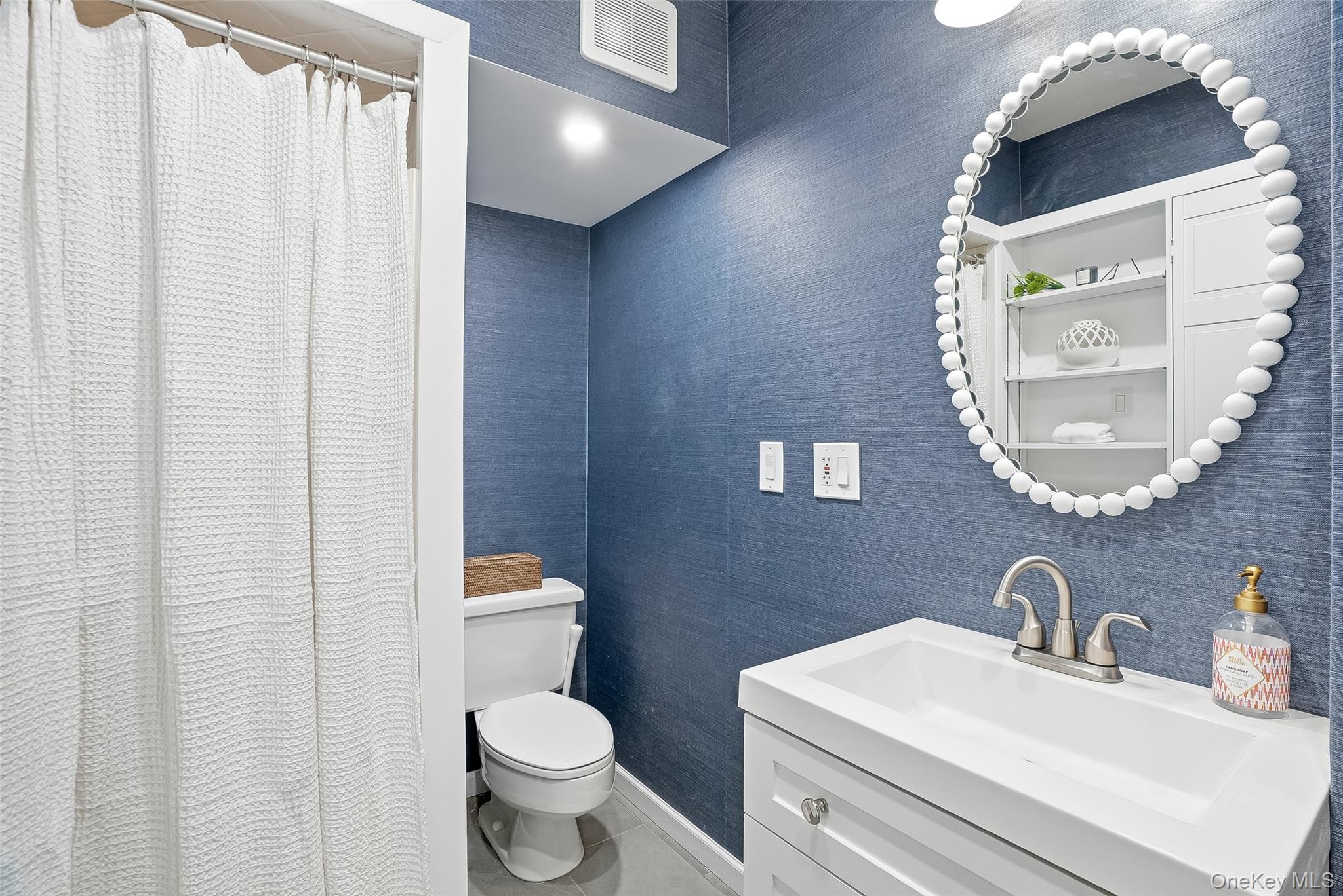 1 Oneida Street Rye, NY 10580 - Photo 16 of 32 a bathroom with a toilet a sink and mirror
