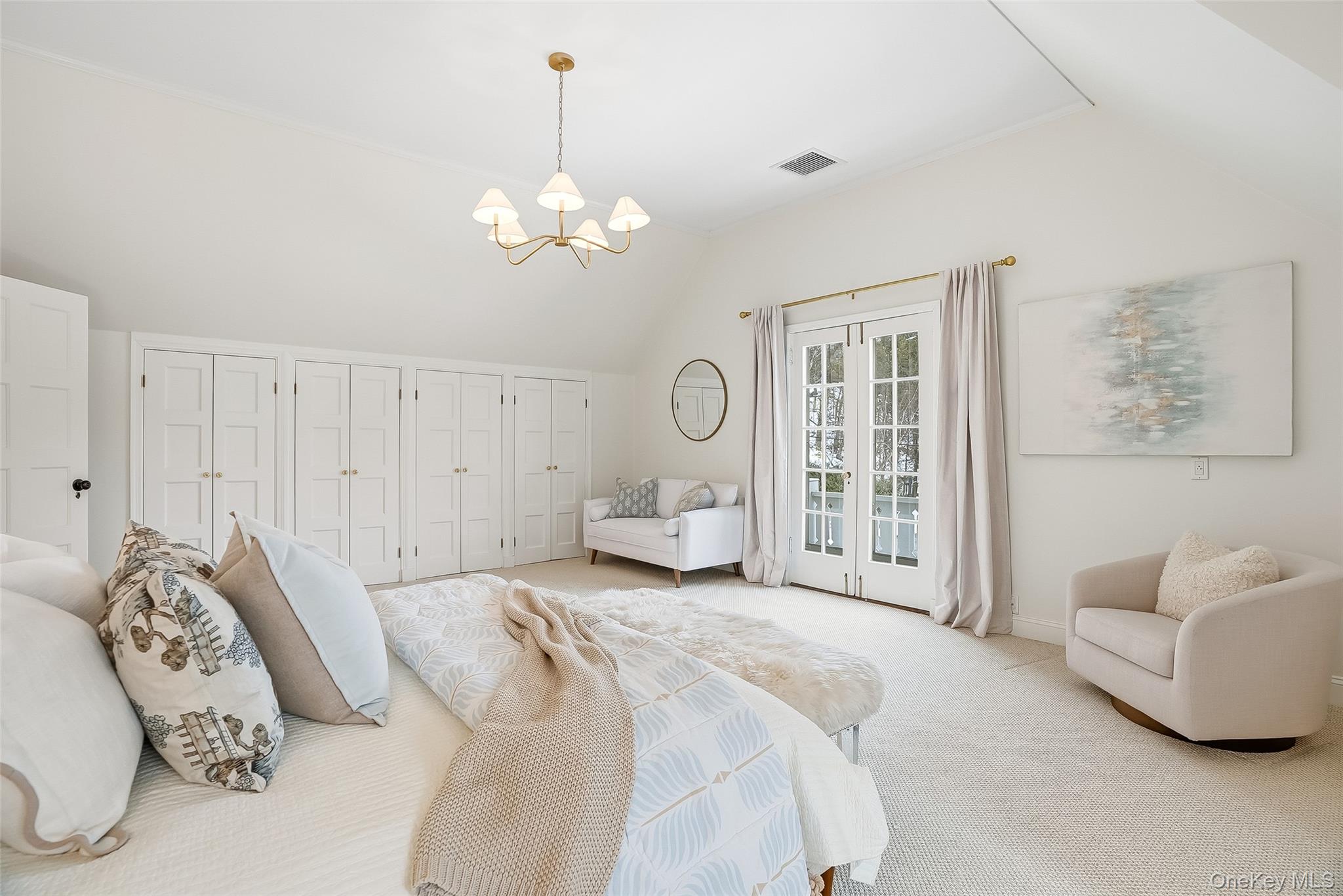 1 Oneida Street Rye, NY 10580 - Photo 18 of 32 a spacious bedroom with a bed mirror and chandelier