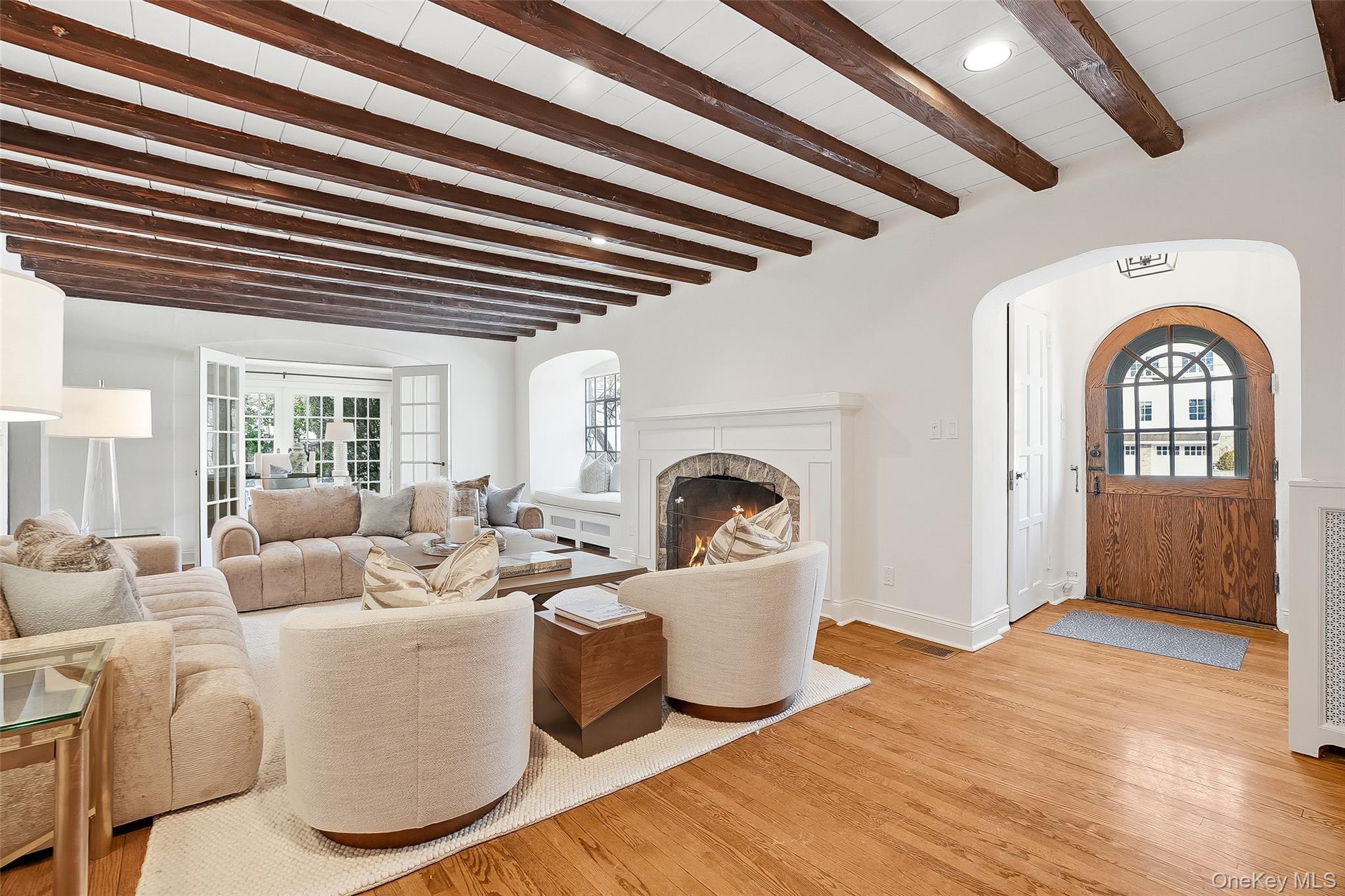 1 Oneida Street Rye, NY 10580 - Photo 3 of 32 a living room with furniture a fireplace and a chandelier