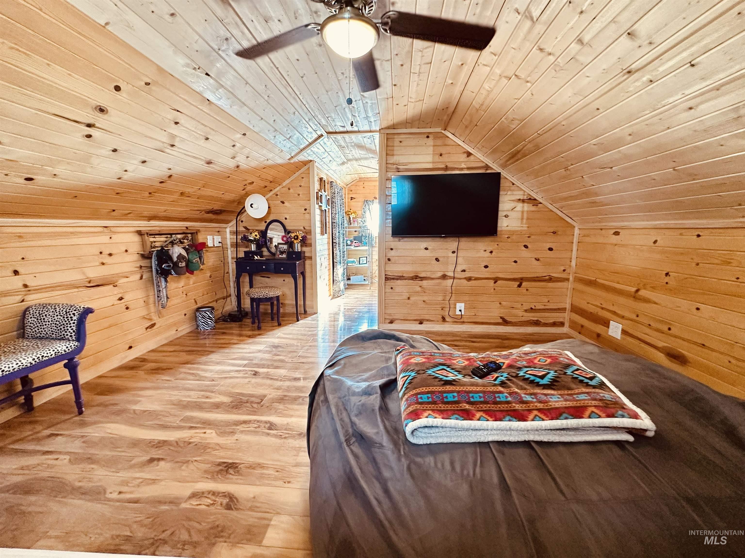 5051 South Rd J Vale, OR 97918 - Photo 12 of 49 Bedroom featuring wood walls, wood ceiling, wood finished floors, and a ceiling fan