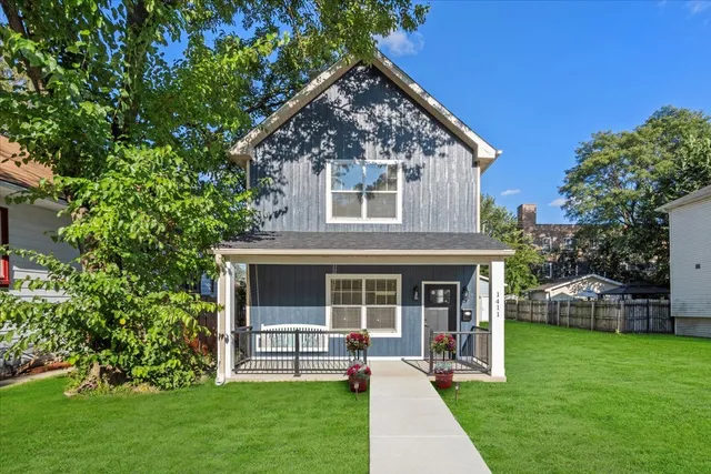 a view of a house with a yard and sitting area