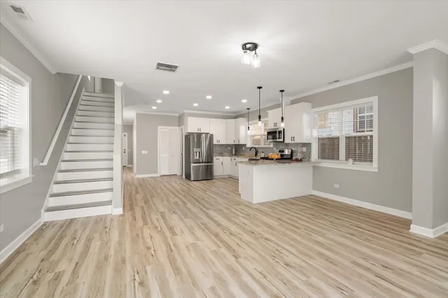 a view of kitchen with cabinets and wooden floor