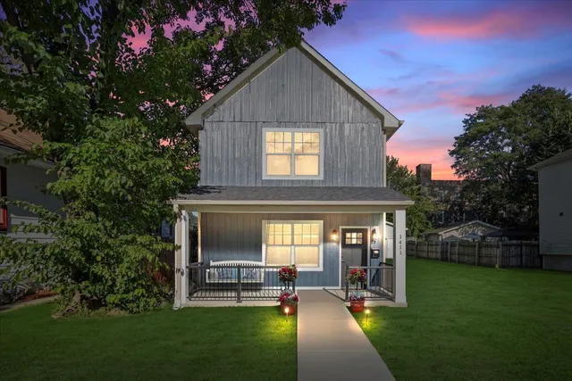 a view of a house with a yard porch and sitting area