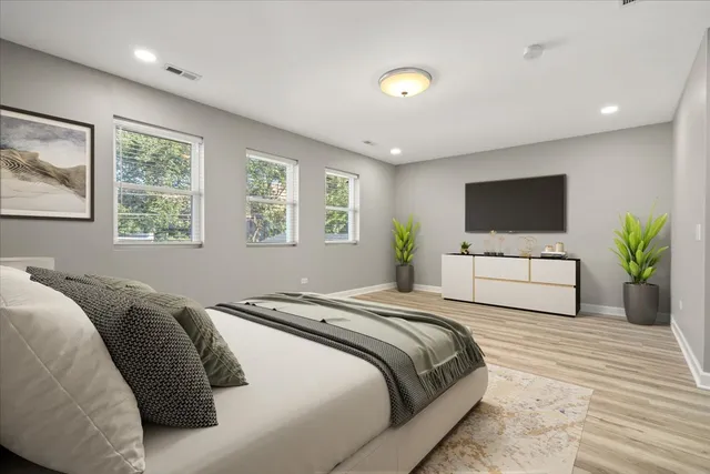 a bedroom with a large bed and a tv