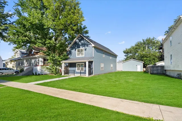 a front view of a house with a garden