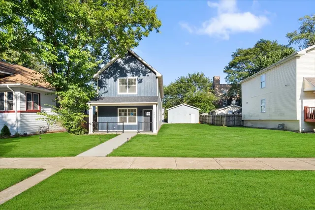 a front view of a house with a garden