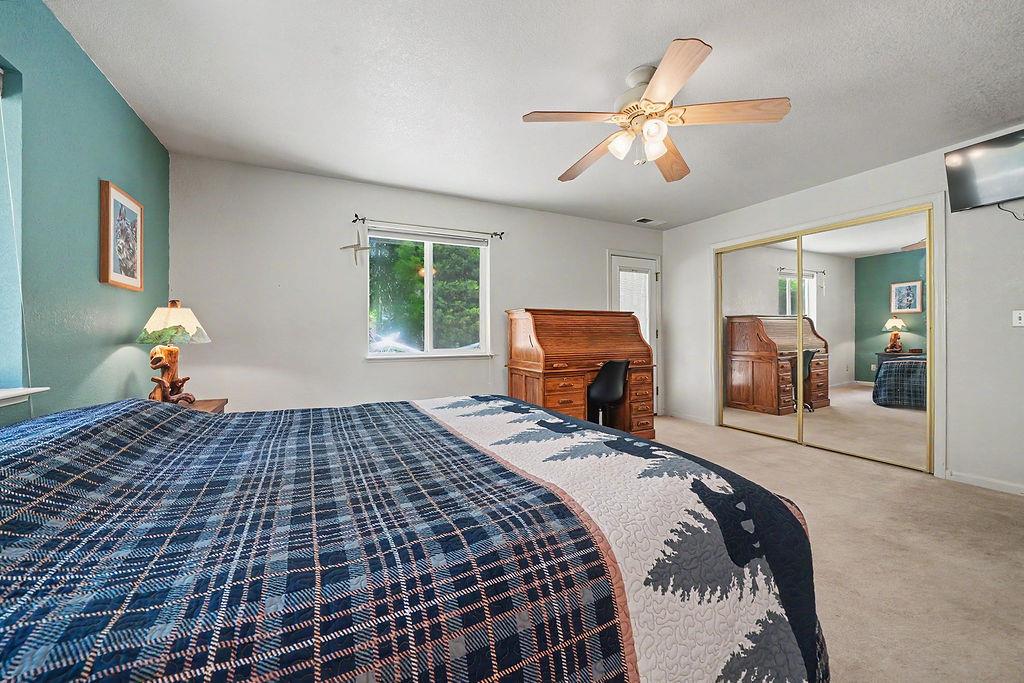 26845 Spring Court Pioneer, CA 95666 - Photo 37 of 89 a bedroom with a large bed and a chandelier